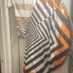 White bodysuit with white black and orange stripe cape